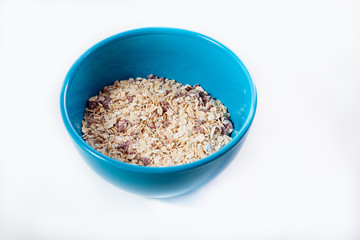 Oat porridge in a bowl. On a white background.