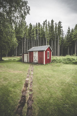 Trail leading up to a small red cabin