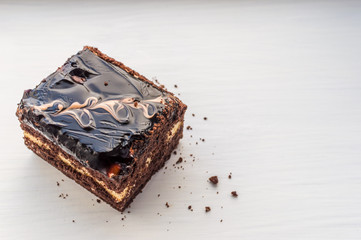 close up of a chocolate syrup on a cake on white background