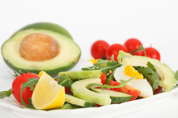 Fresh healthy sald with avocado, tomato, eggs and rucola lettuce