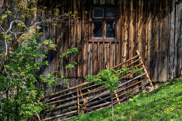 Old house made of wood with window and fence