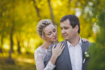 Fototapeta premium Portrait of a beautiful married couple on the background of bright autum