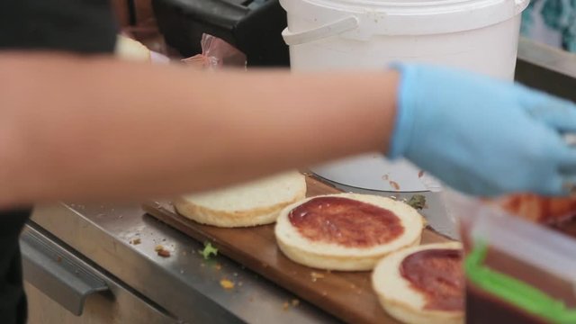 Close up of chef's hands that prepare burgers