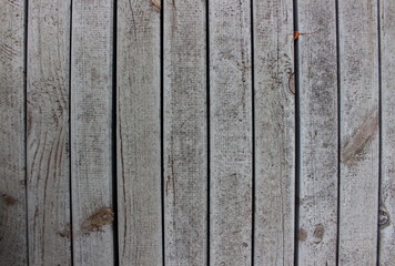 Old rough wooden boards of gray color with rusty nails close-up with soft focus.
