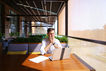 Caucasian realtor working with laptop and chatting with client o