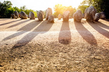 Sunrise view on the menhirs stones in megalithic monument of Cromelech dos Almendres in Portugal