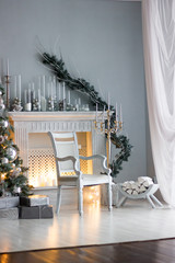 Christmas decoration - room with beautiful chair, fireplace and christmas tree