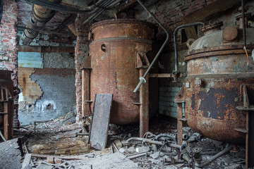 Rusty industrial containers for nitric acid in abandoned factory