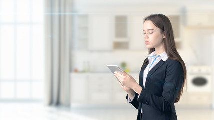 Young beautiful business woman and creative designer standing over blured interior background