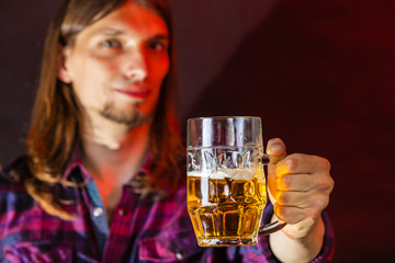 Young man drinking pint.