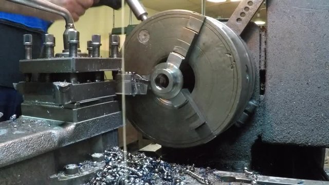 Man working on a lathe in a workshop
