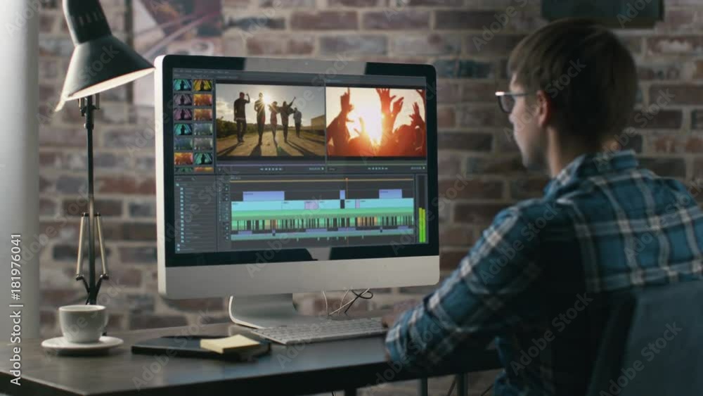 Poster video editor works with footage and sound on his personal computer. his office is modern and creativ