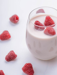 Light raspberry yogurt, yoghurt  on the white wood table 
