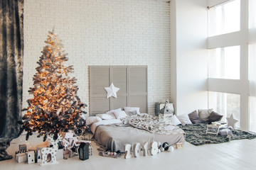 On new-year a room is decorated with a fire-place and new-year tree