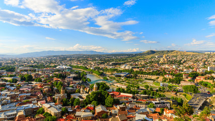 Fototapeta na wymiar Panoramic view of Tbilisi city from the Saint mount (Mtatsminda), old town and modern architecture. Tbilisi the capital of Georgia