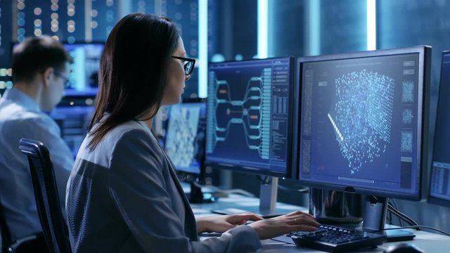 In Hi-Tech AI Research Center Female IT Engineer Working on a Neural Network Project, She Uses Personal Computer, Screen Shows Her Progress.