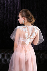 Fototapeta premium bride in a beautiful peignoir in interior