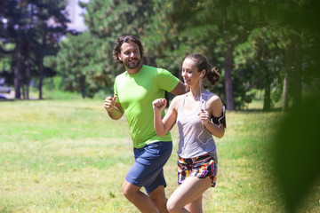 Fototapeta premium Healthy, fit and sportive couple running in park