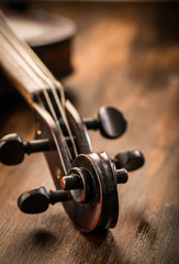 Violin in vintage style on wood background