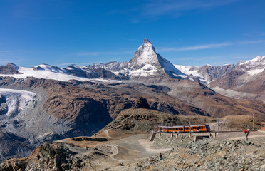 Red train to Gornergrat  over Matterhorn peak in Switzerland.