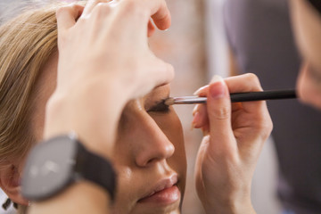makeup artist applying eyes makeup