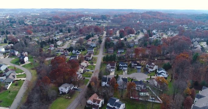 A daytime late Autumn aerial establishing shot of a typical Western Pennsylvania neighborhood. Pittsburgh suburb.  	