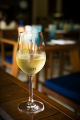 Glass with cold white wine at restaurant