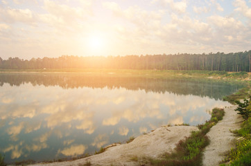 Fototapeta premium Blue and orange sky from sunset on the lake.