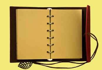 Top view image of open notebook with blank pages isolated on a yellow background, ready for adding text