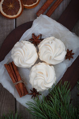Obraz na płótnie Canvas Homemade zephyr or marshmallows with mulled wine cinnamon oranges, anis. Christmas atmosphere. Flat lay