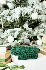 Cute handmade christmas present. Knitted green mittens.