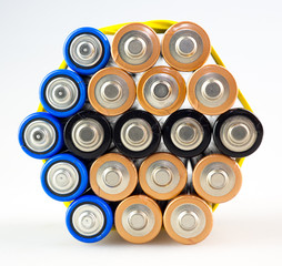 Arrow from multicolored batteries, AA batteries, white background, macro