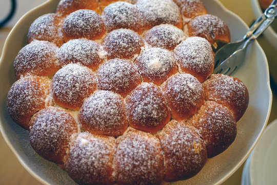 Plate of round German Buchteln filled brioche buns 