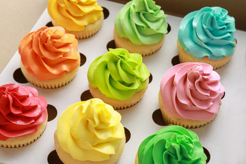 Tasty colorful cupcakes in cardboard box