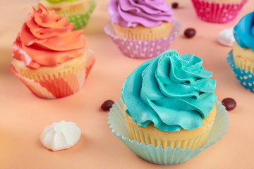 Tasty cupcakes on color background