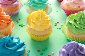 Tasty cupcakes on color background
