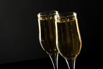 glass of champagne on black background