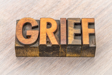 grief word abstract in wood type