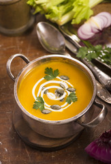 pumpkin soup on rustic wooden background