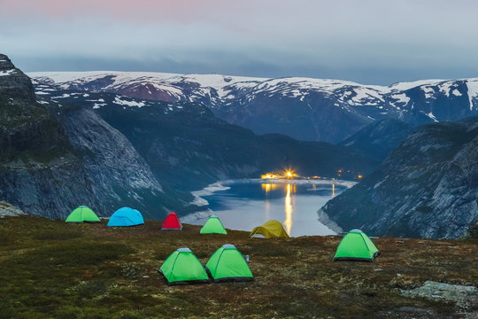 Campsite at the edge of cliff over Ringedalsvatnet lake nearby iconic landmark Trolltunga. Norway, Scandinavia, Europe. Famous and very popular travel destination in Norway for active people.