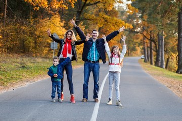 Obraz premium A happy family having fun in the park in autumn. Family, love, happiness concept. Family of four