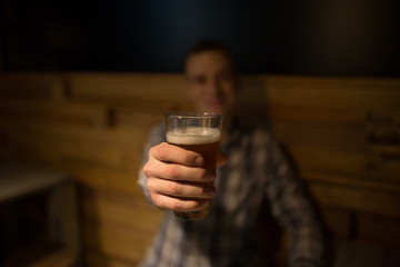 Man in pub giving beer 