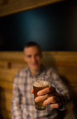 Man in a pub holding craft beer