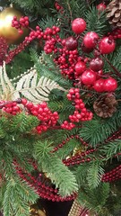 The Christmas tree is unusually decorated, with a branch of garlands with red winter berries, a kind of postcard or background