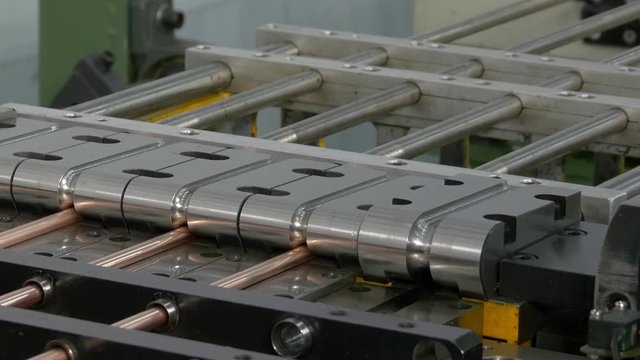 Bending and cutting metal copper pipes tubes on industrial CNC machine. Automation of work. Refrigeration and ventilation equipment and air conditioners. Modern technologies.