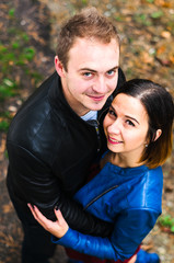 Fototapeta premium The guy with the girl walking in the Park , in a good mood. dressed in jackets, autumn time.