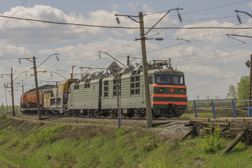 Fototapeta na wymiar Green freight train transports cargo by rail