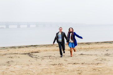 the guy with the girl a walk along the coast . . deserted beach , dirty sand .