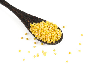 millet in a wooden spoon