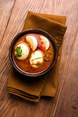 Tuinposter Anda Curry or Egg Curry or Egg masala gravy, indian spicy food or recipe, served with roti or naan, selective focus   © StockImageFactory